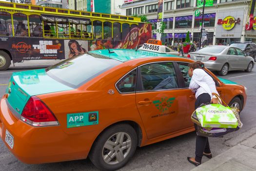 A woman taking a taxi in Toronto city, Canada.