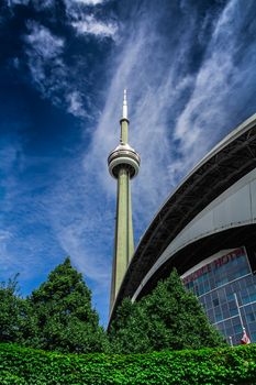 The CN Tower on a blue sky background in beautiful day. Its location is in Toronto, Canada.