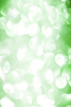 The sparkling blur abstract green background.