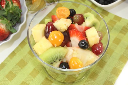a cocktail glass with fresh fruit salad