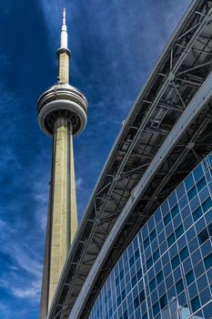 The CN Tower on a blue sky background in beautiful day. Its location is in Toronto, Canada.