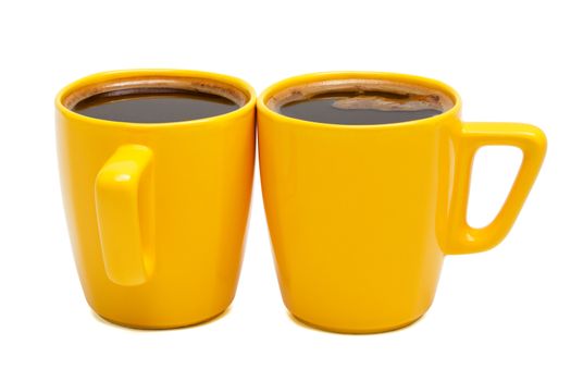 two yellow mugs of coffee on a white background