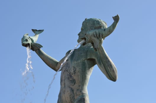 Statue of boy with fish