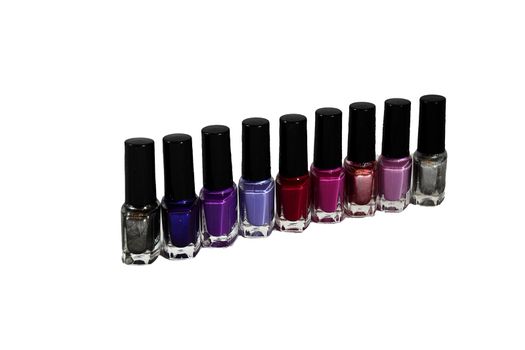 On a white background nine bottles of nail polish in different colors