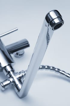 modern metal faucet and shower close up