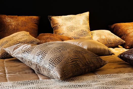 leather pillows on the bed in a modern bedroom