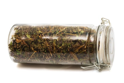 herbs in a jar on a white background