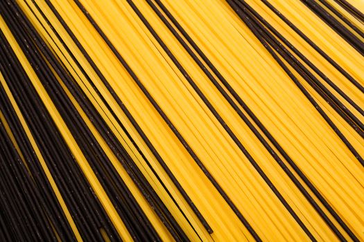 black and yellow pasta close-up as a background