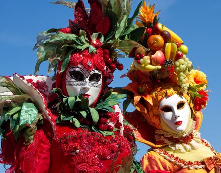 Beautiful colorful persons with lots of fruits at the 2014 Annecy venetian carnival, France