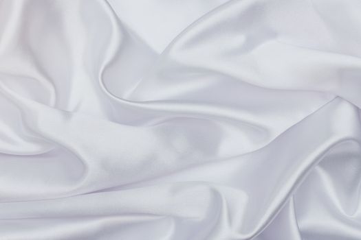 Closeup of white satin fabric as background