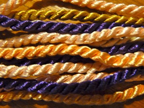 Bright colourful twisted twine ropes in undulating lines