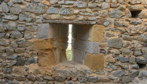 loophole into the stone walls of a medieval castle