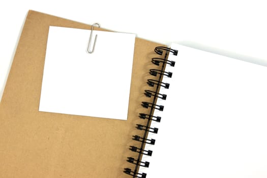 White note paper clip on brown cover note book
