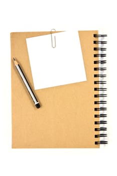 White note paper clip on brown cover note book with pencil