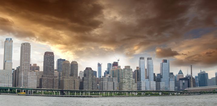Panoramic view of Manhattan East Side with cloudy sky.
