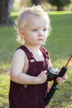 Cute Young Boy With Fishing Pole Outside at The Lake.