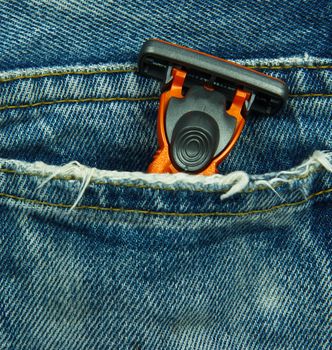 Closeup to jeans pocket with shaving razor