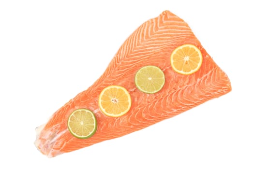 Red fish fillet with lemon slices. Isolated on a white background.