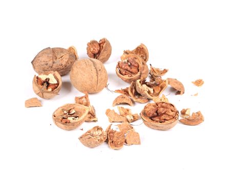 Heap of cracked walnuts. Isolated on a white background.
