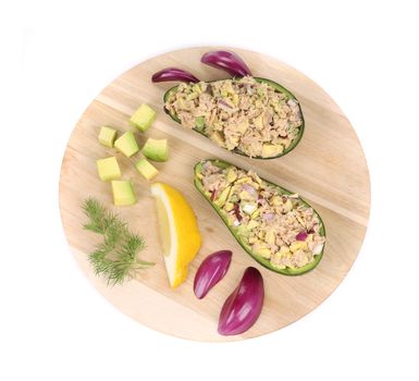Avocado salad with tuna on platter. Isolated on a white background.