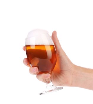 Hand holds glass of beer. Isolated on a white background.