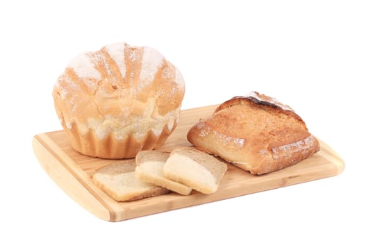 Various types of bread on cutting board. Isolated on a white background.