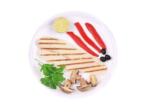 Grilled fish fillet with vegetables. Isolated on a white background.