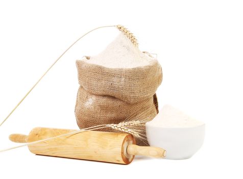 Whole flour in bag with wheat ears. Isolated on a white background.