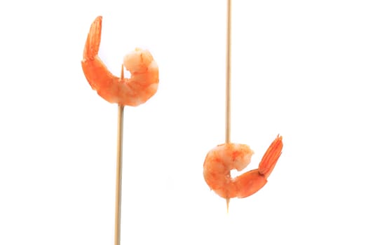 Boiled shrimps on skewers. Isolated on a white background.