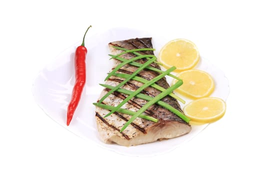 Grilled fish with vegetables. Isolated on a white background.