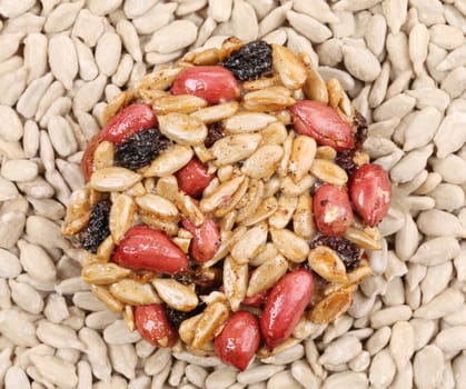 Sunflower seeds and raisins in caramel. Isolated on a white background.