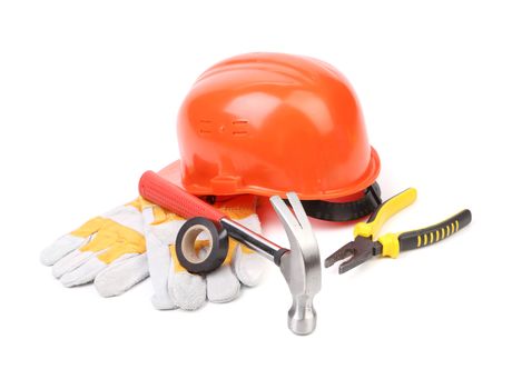 Hard hat, hammer, pliers and work gloves. Isolated on a white background.