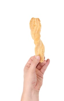 Hand holding stick cracker with sesame seeds. Isolated on a white background.