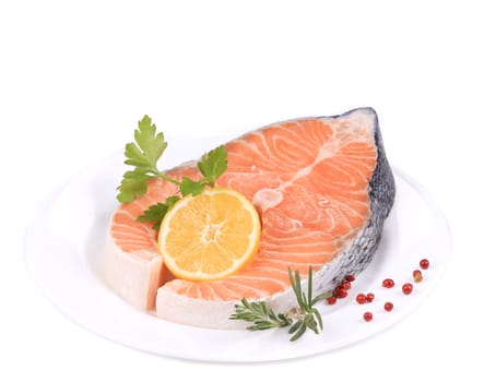 Raw salmon steak with lemon. Isolated on a white background.