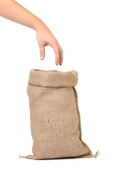 Sack with wheat flour and hand. Isolated on a white background.