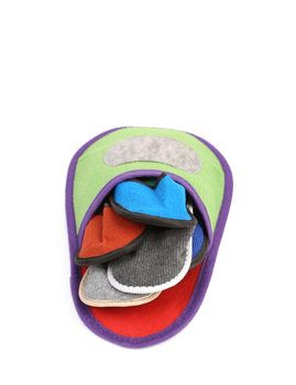 Colourful slippers into big slipper. Isolated on a white background.