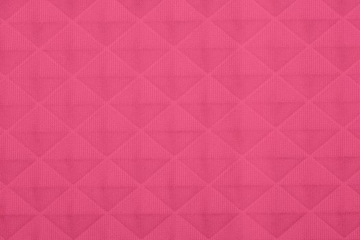 Pink fabric with geometric patterns, a background or texture