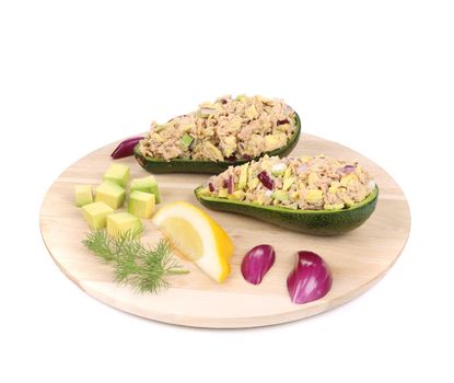 Avocado salad with tuna on platter. Isolated on a white background.