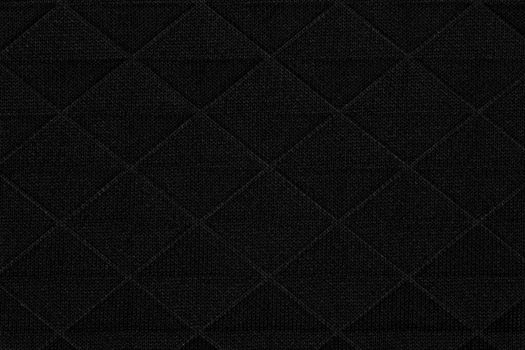 Black fabric with geometric patterns, a background or texture