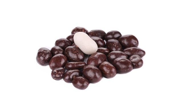 Dark brown dragee in chocolate cover. Isolated on a white background.