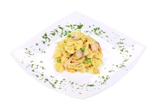 Pasta with ham and mushrooms in sauce pesto. Isolated on a white background.