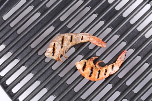 Grilled shrimps on grill. Close up. Whole background.