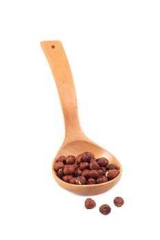 Wooden spoon with nuts. Isolated on a white background.