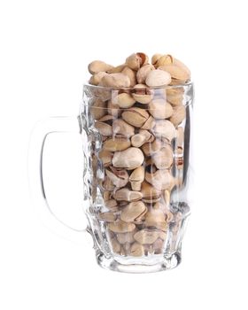 Beer mug full of pistachios. Isolated on a white background.