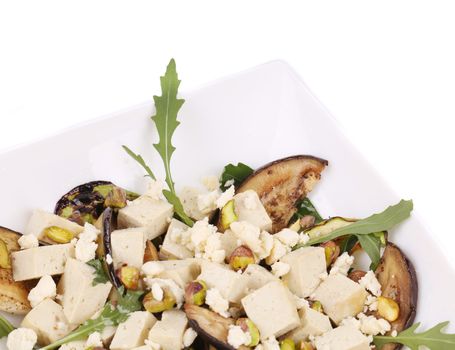 Salad with grilled vegetables and tofu. Isolated on a white background.