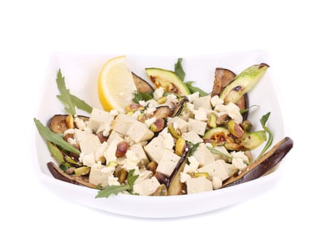 Salad with grilled vegetables and tofu. Isolated on a white background.