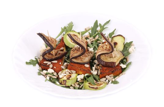 Salad with grilled vegetables and tofu. Isolated on a white background.