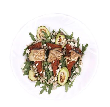 Salad with grilled vegetables and tofu. Isolated on a white background.