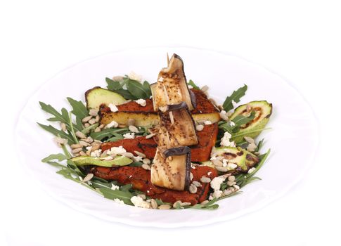 Salad with grilled vegetables and tofu. Isolated on a white background.