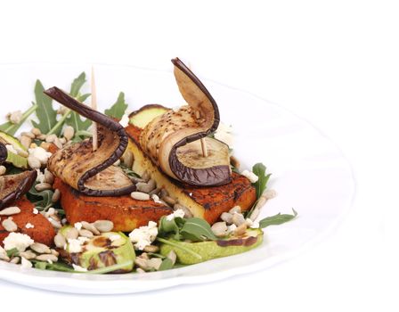 Salad with grilled vegetables and tofu. Isolated on a white background.
